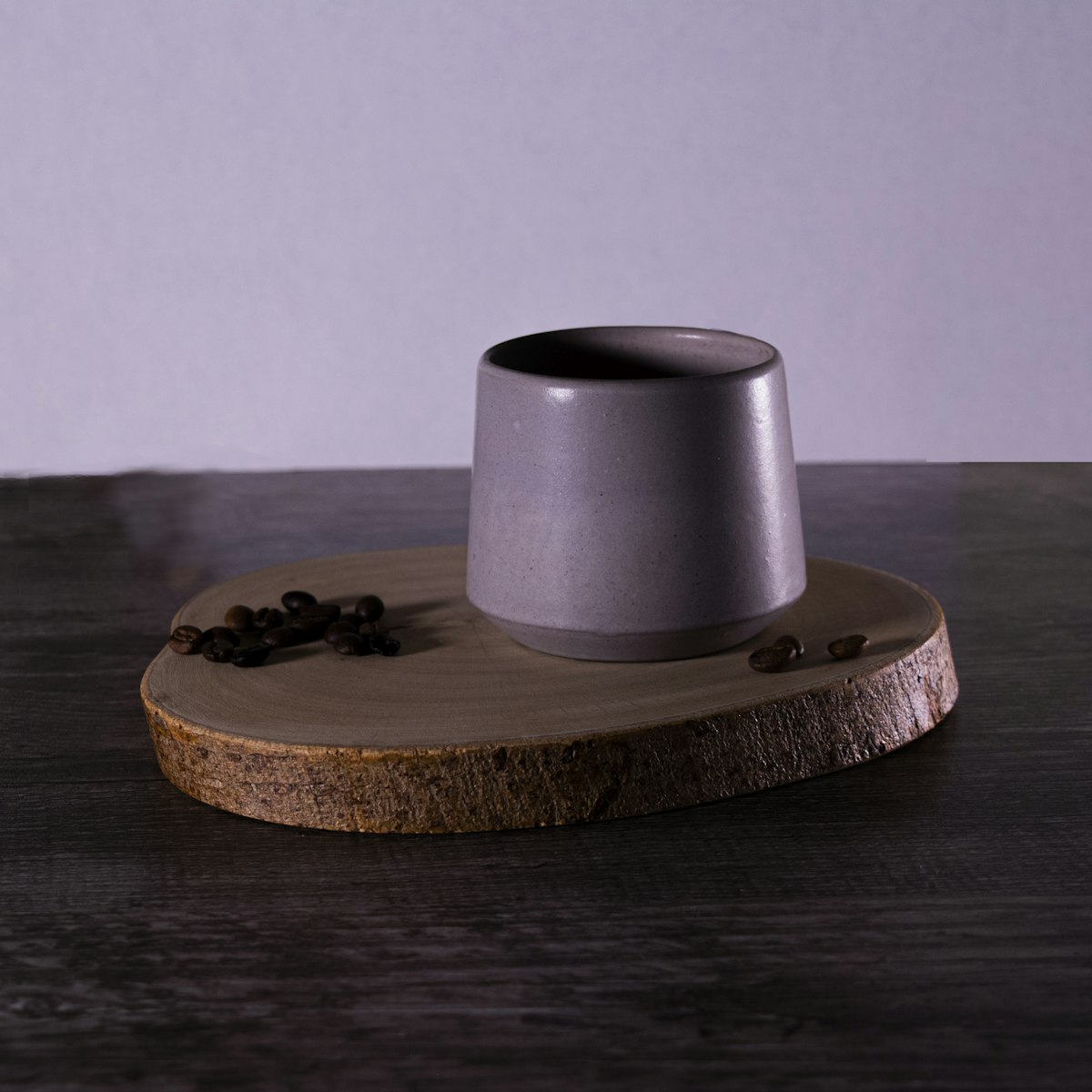 A lilac tumbler on a slice of wood